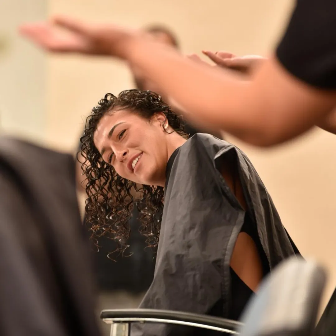Caroline Smalley styling a curly-haired guest at the Curl Identity studio