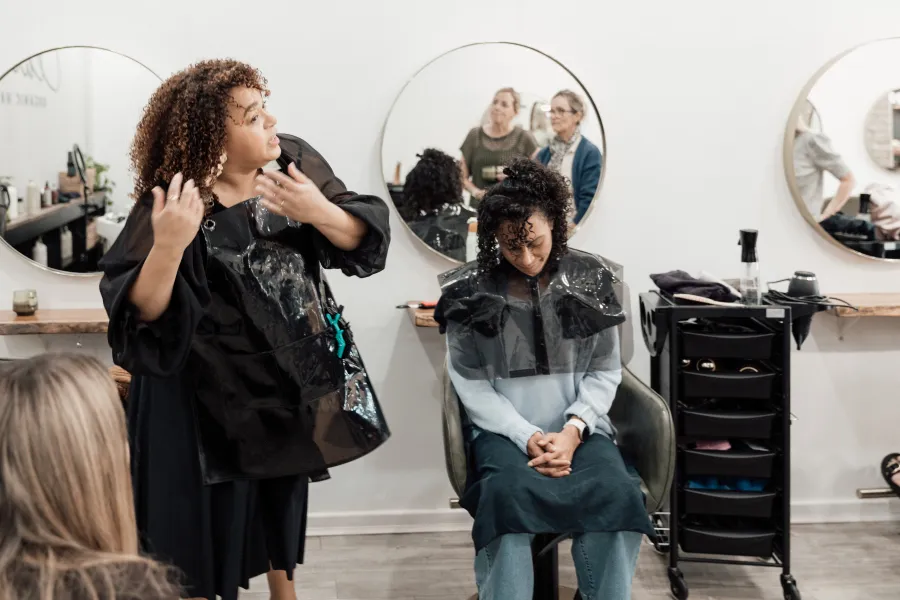Caroline teaching stylists during a Curl Identity education session