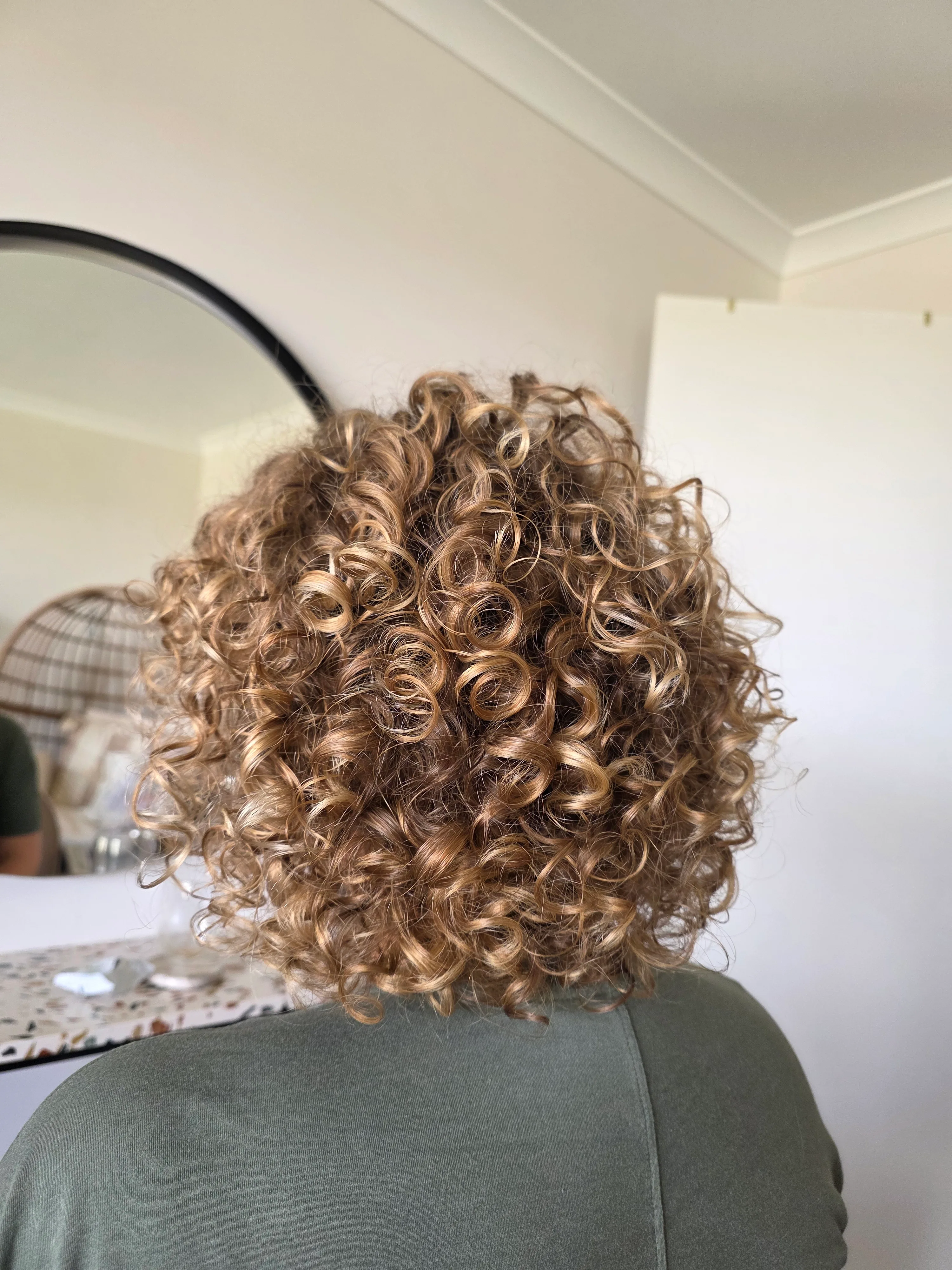 Honey-blonde defined curls, top-down view