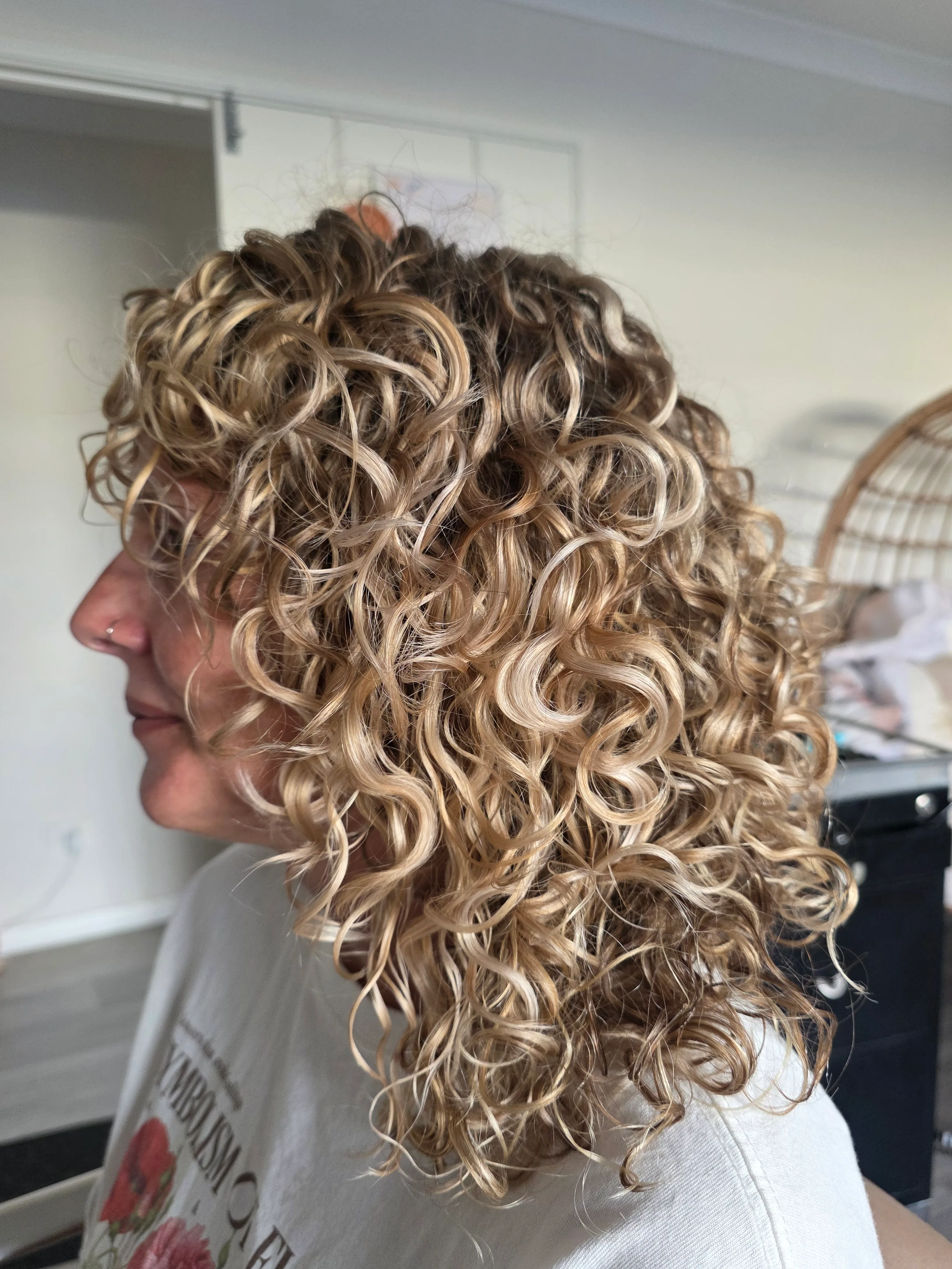 Blonde curls shaped and styled at Curl Identity