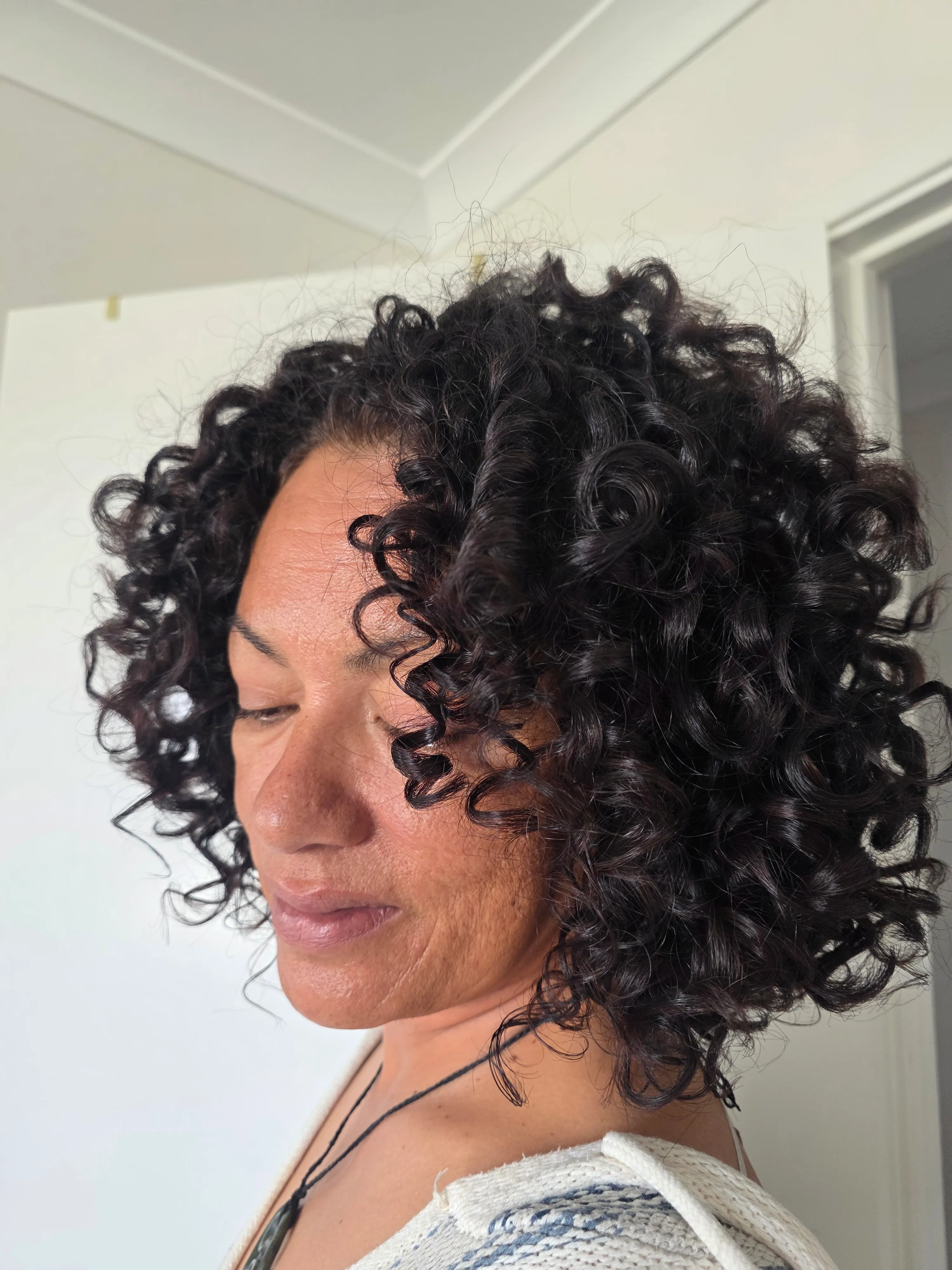 Soft, defined dark curls on a mature guest