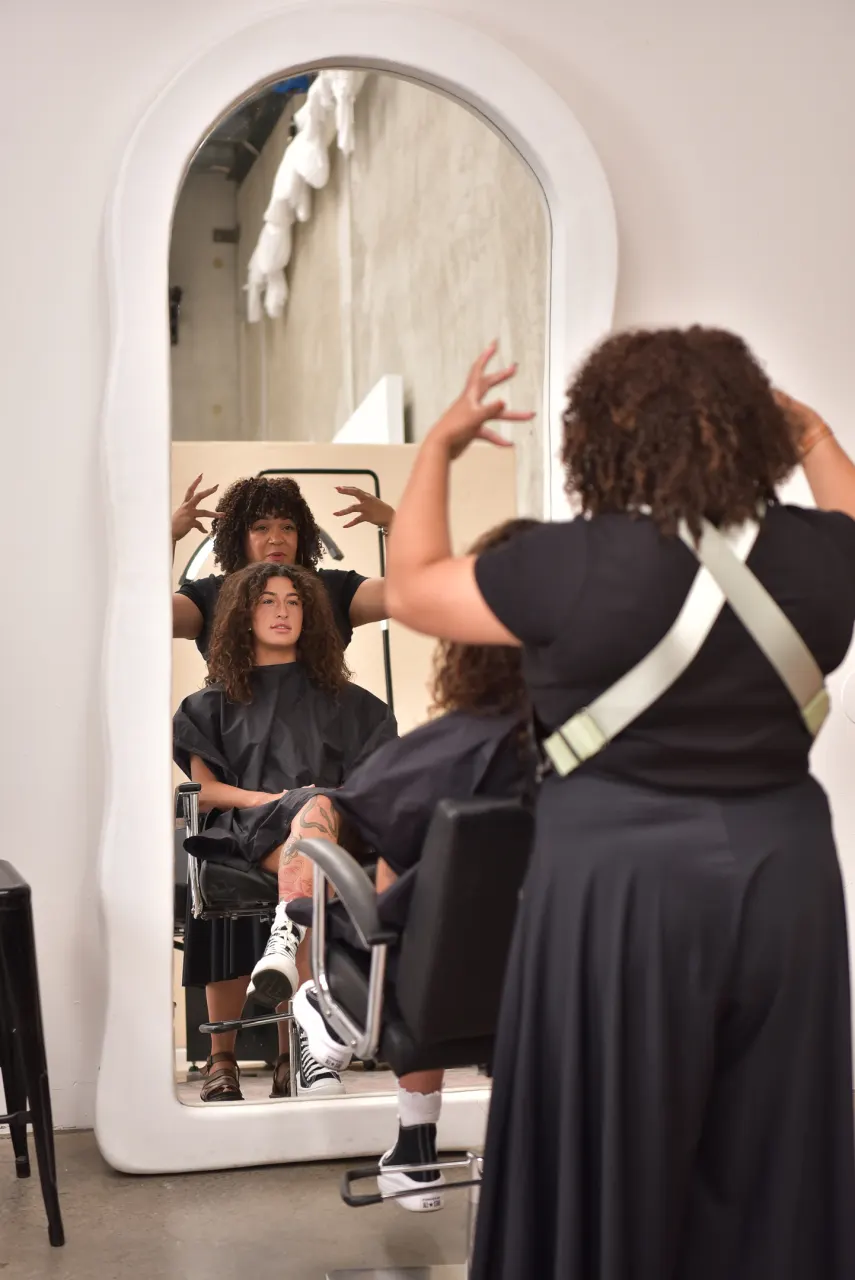Caroline Smalley styling a curly-haired guest at the Curl Identity studio